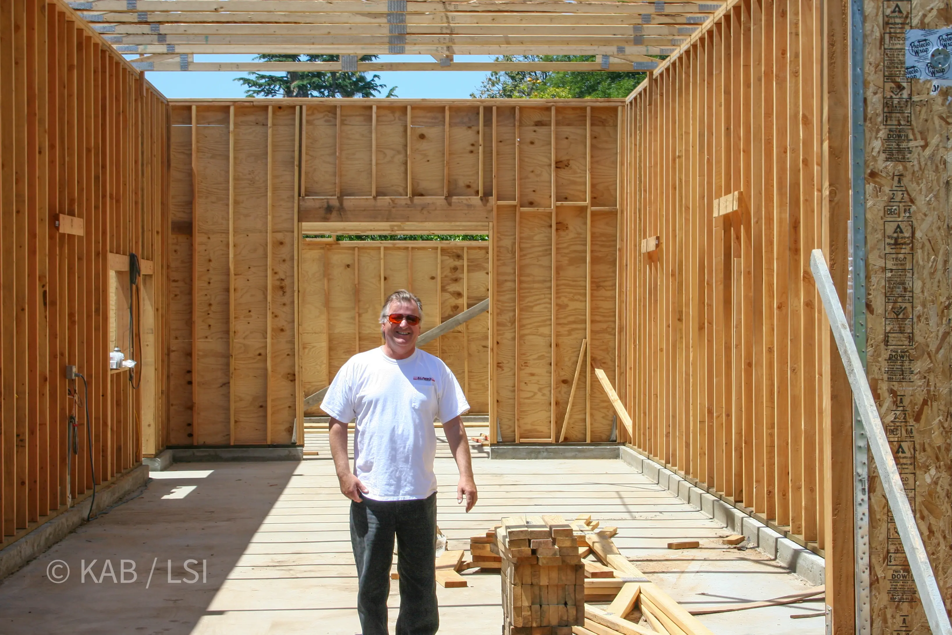 Kenny with his diesel-mechanic friend inside the RV garage shell — the space he always wanted © KAB/LSI