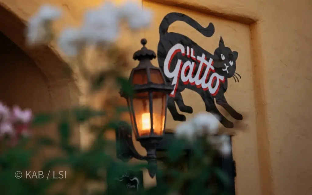 Il Gatto restaurant in Whittier, California — the Friday-evening dinner table where Keith Bennett and a hillside client continue the conversation that started on the property.