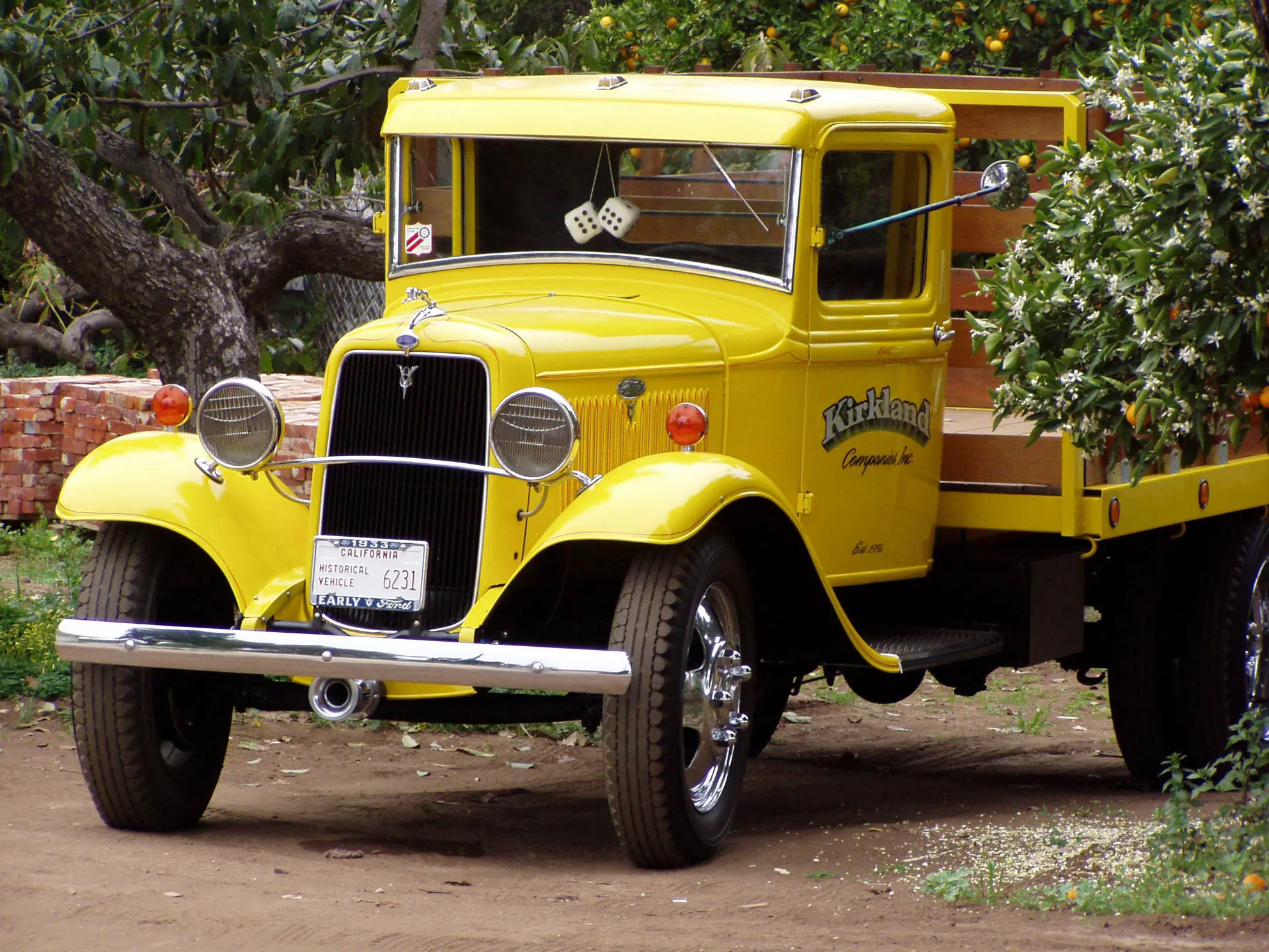 A vintage yellow Ford truck parked in a La Habra Heights driveway