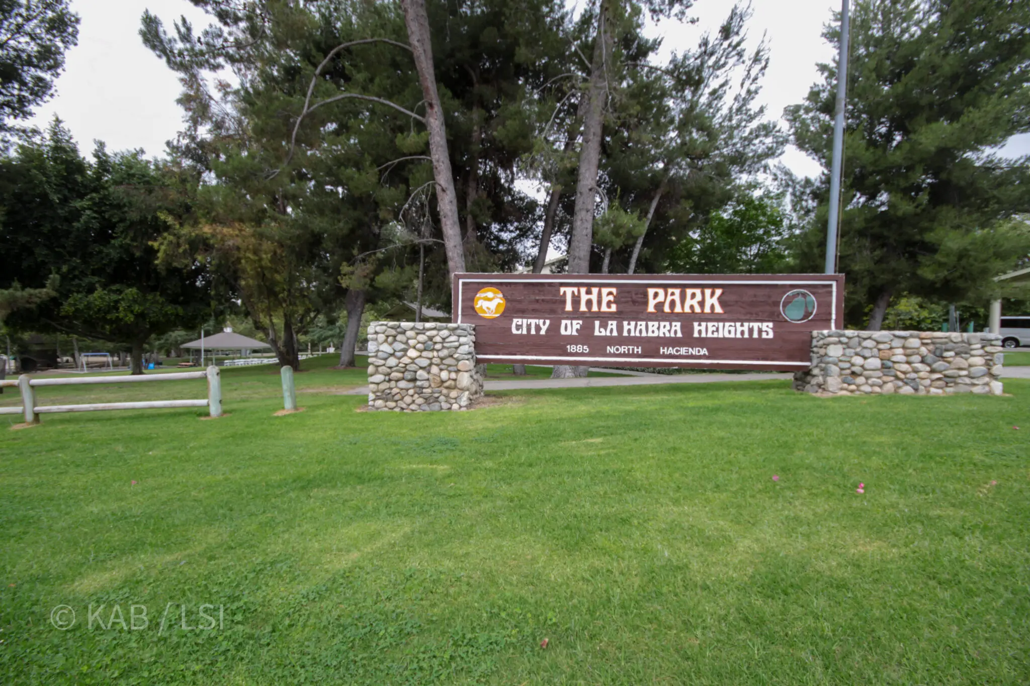 The Park, City of La Habra Heights wood sign at 1885 North Hacienda — the city park entrance with stone walls and tall pines