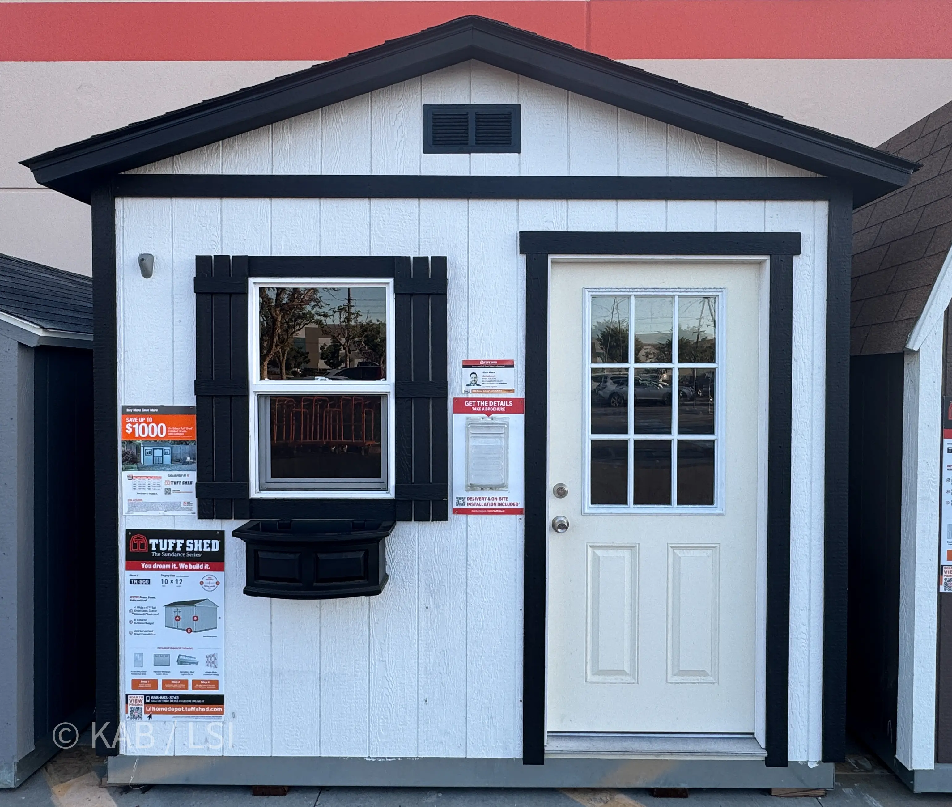 Tuff Shed Sundance Series TR-800 10 by 12 white cottage shed with shutters and flower box at Home Depot