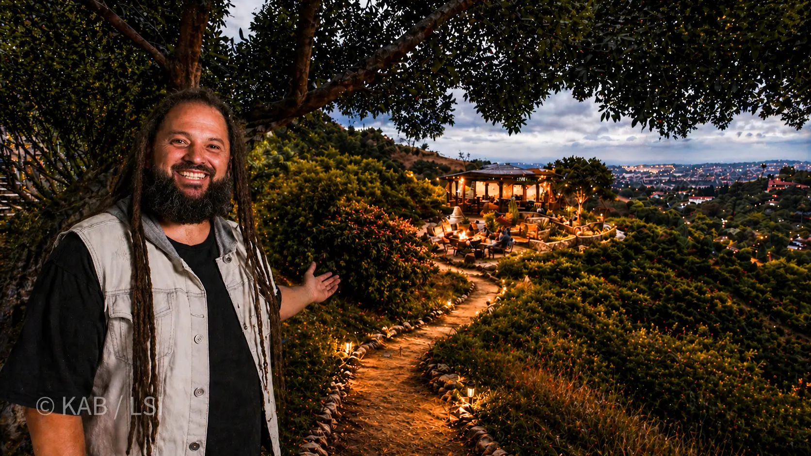 The same hillside corner at dusk, rendered with a destination pavilion, lit stone path, and city lights below. © KAB / LSI