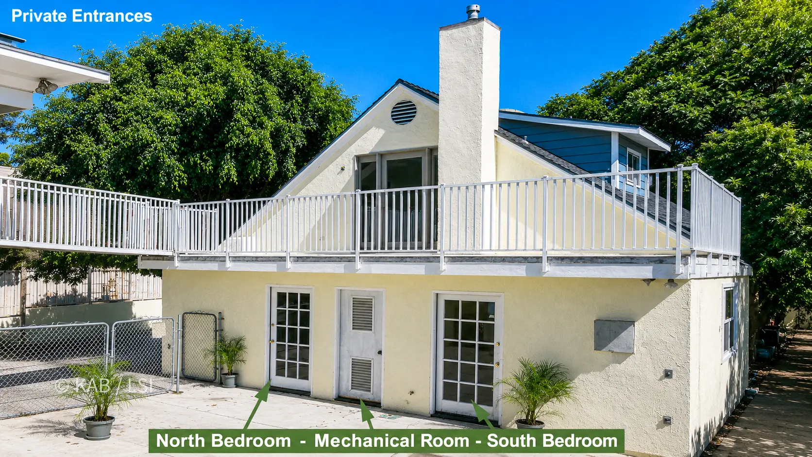 Back of the main house showing two ground-floor bedrooms with private entrances and a new mechanical room.