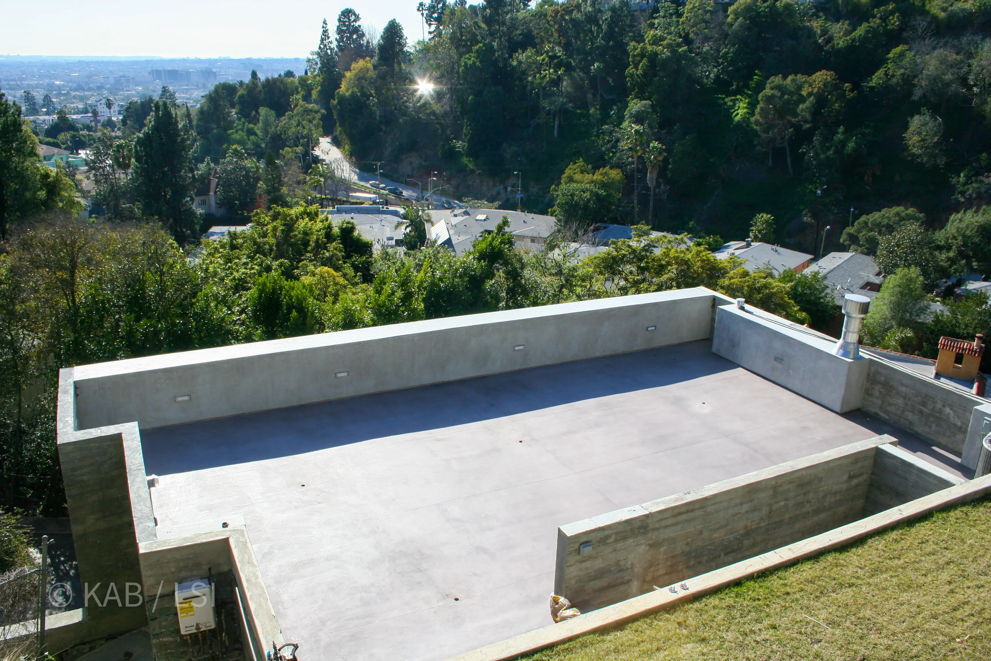 Completed concrete rooftop observation deck on a hillside home looking out over Beverly Hills, Hollywood and the Los Angeles basin toward the ocean