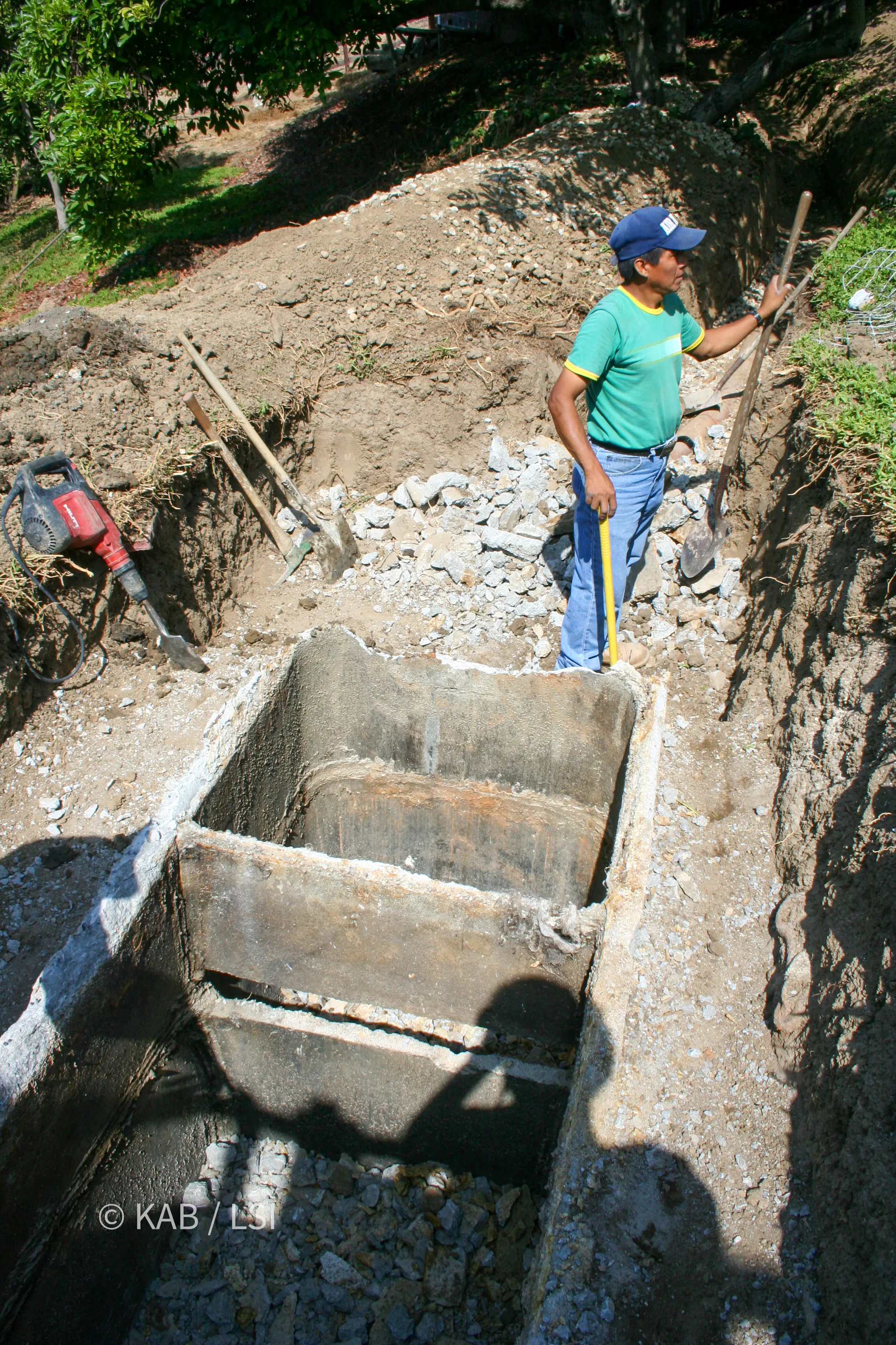 A 1950s concrete septic tank demolished open to expose its interior and dividing wall