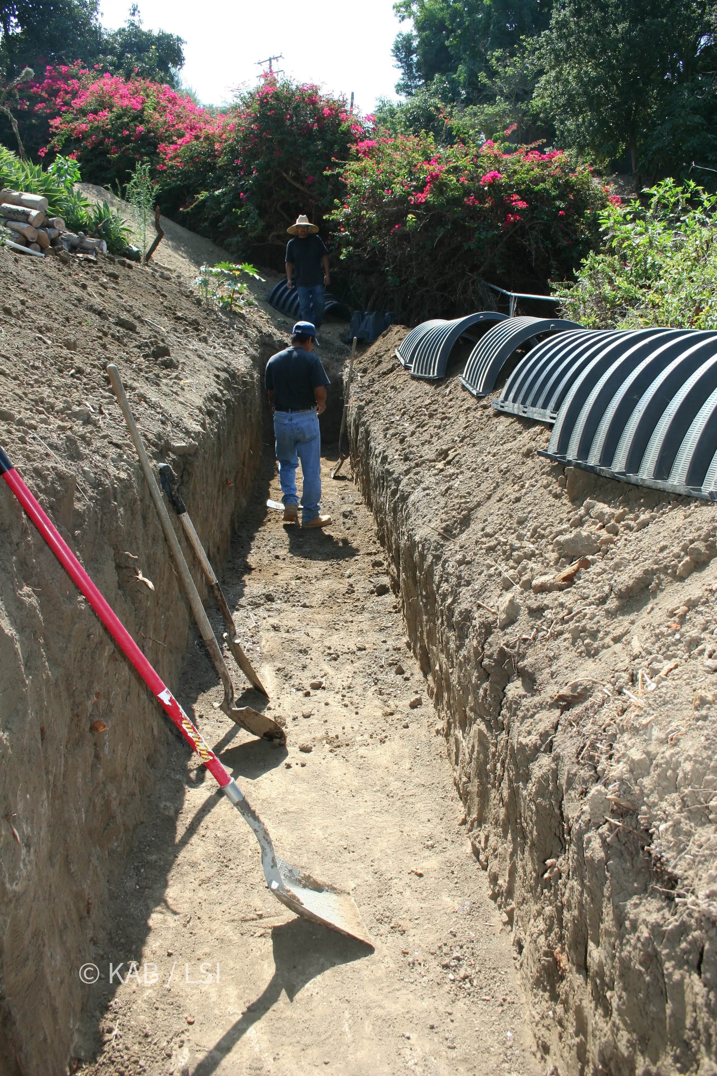 Modern chamber leach field replacing an original open-jointed clay leach field on a hillside property