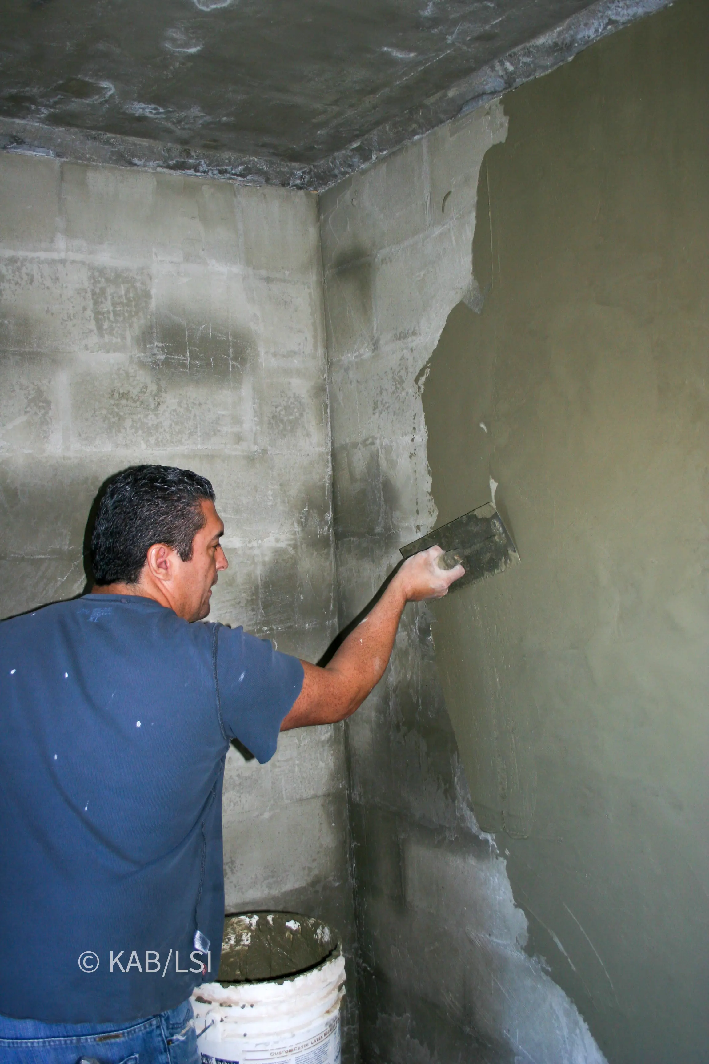 Interior plaster finish being applied inside a reinforced concrete safe room