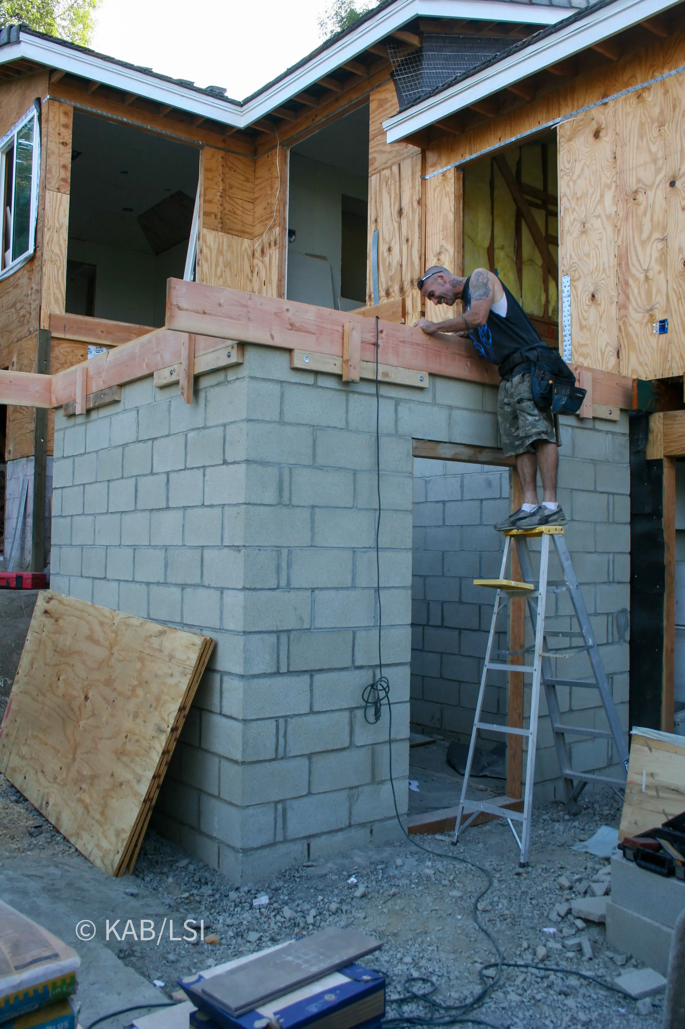 Reinforced concrete safe room being concealed beneath the front entry landing of a hillside home