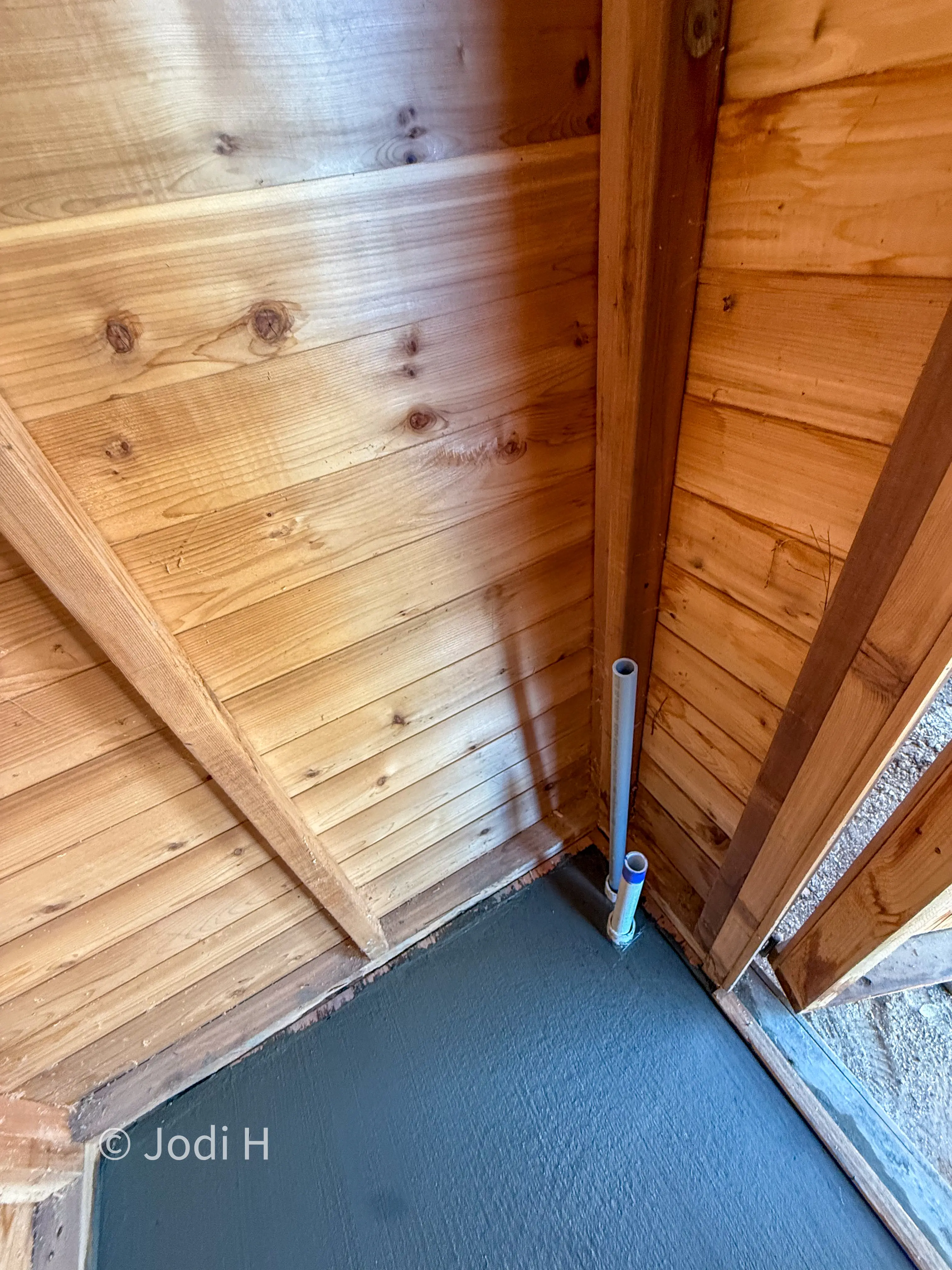 Water service riser and piping inside a cedar water shed on a hillside property in La Habra Heights