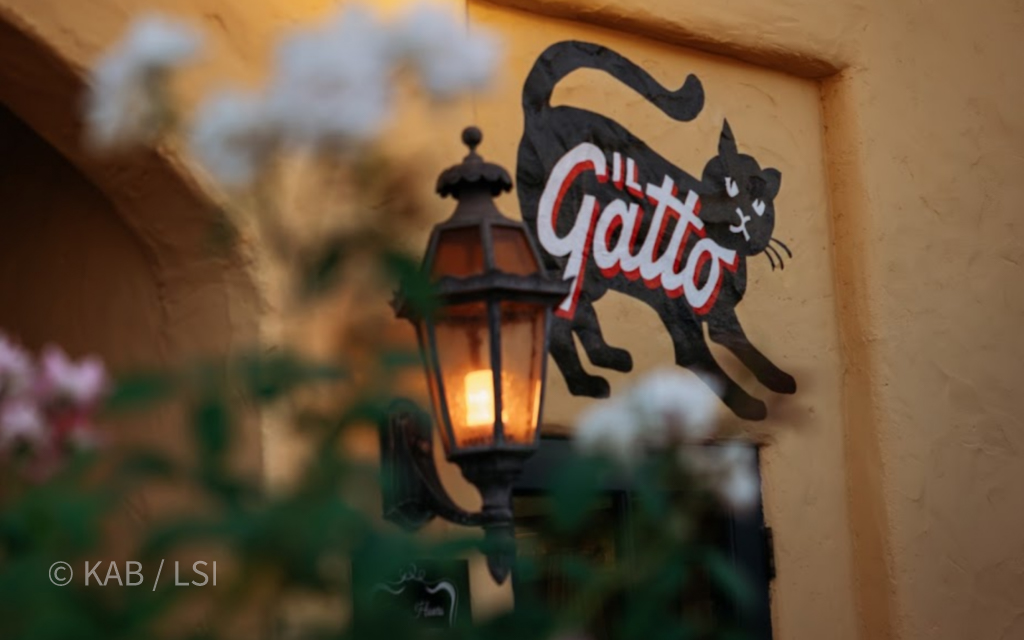 Il Gatto restaurant in Whittier, California — the Friday-evening dinner table where Keith Bennett and a hillside client continue the conversation that started on the property.