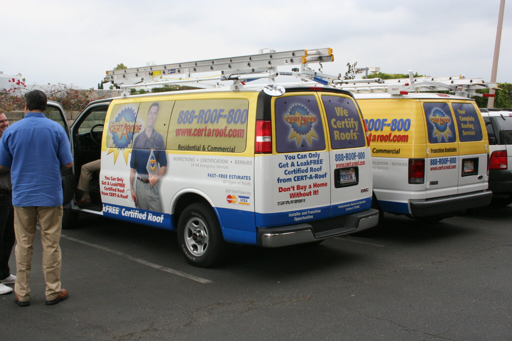 Cert-A-Roof fleet of vans — multiple vehicles at franchise event © KAB/LSI