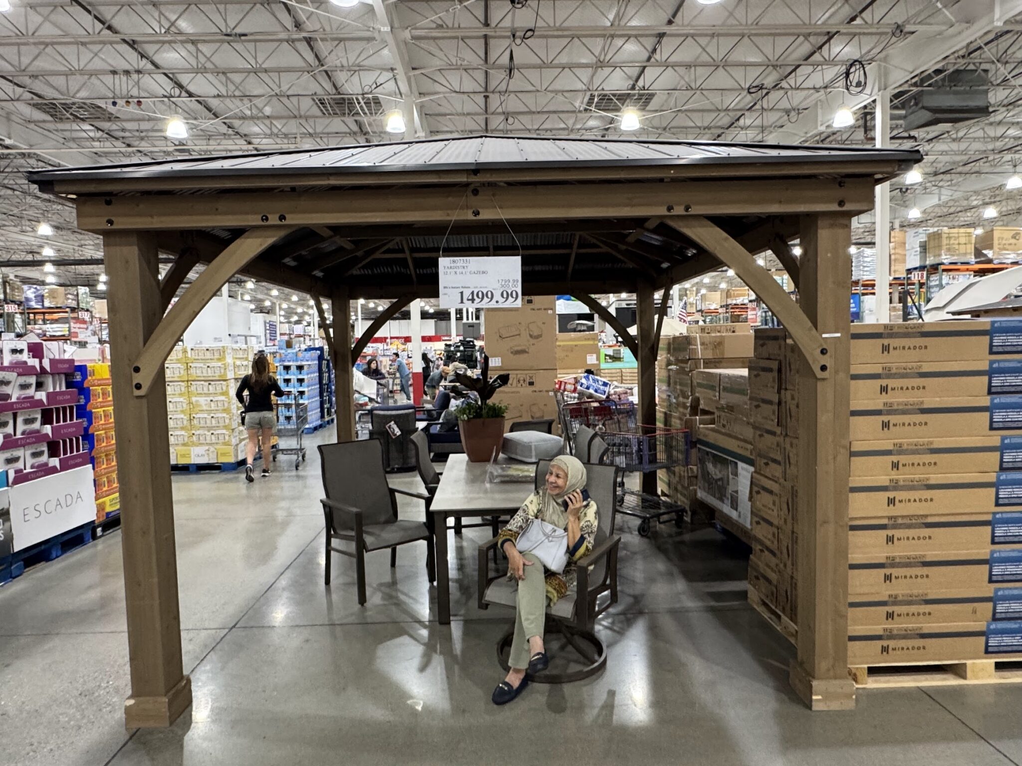 Costco cedar gazebo with metal roof display priced at 1499 dollars — attractive but no concrete pad no utilities no plan