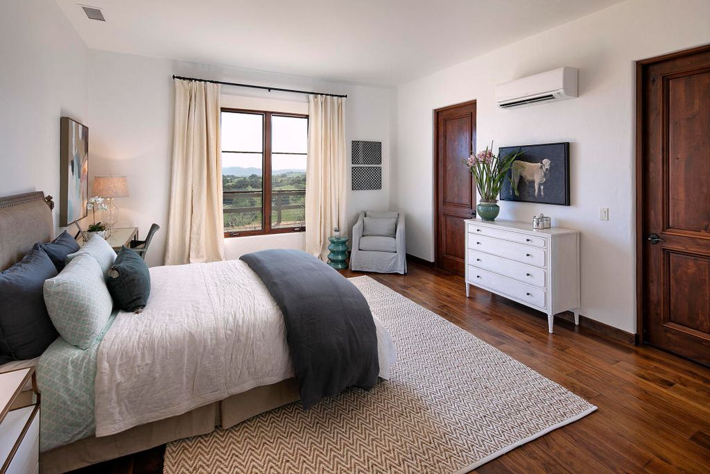 Mitsubishi mini split wall unit installed in master bedroom of La Habra Heights home with California hillside view through window