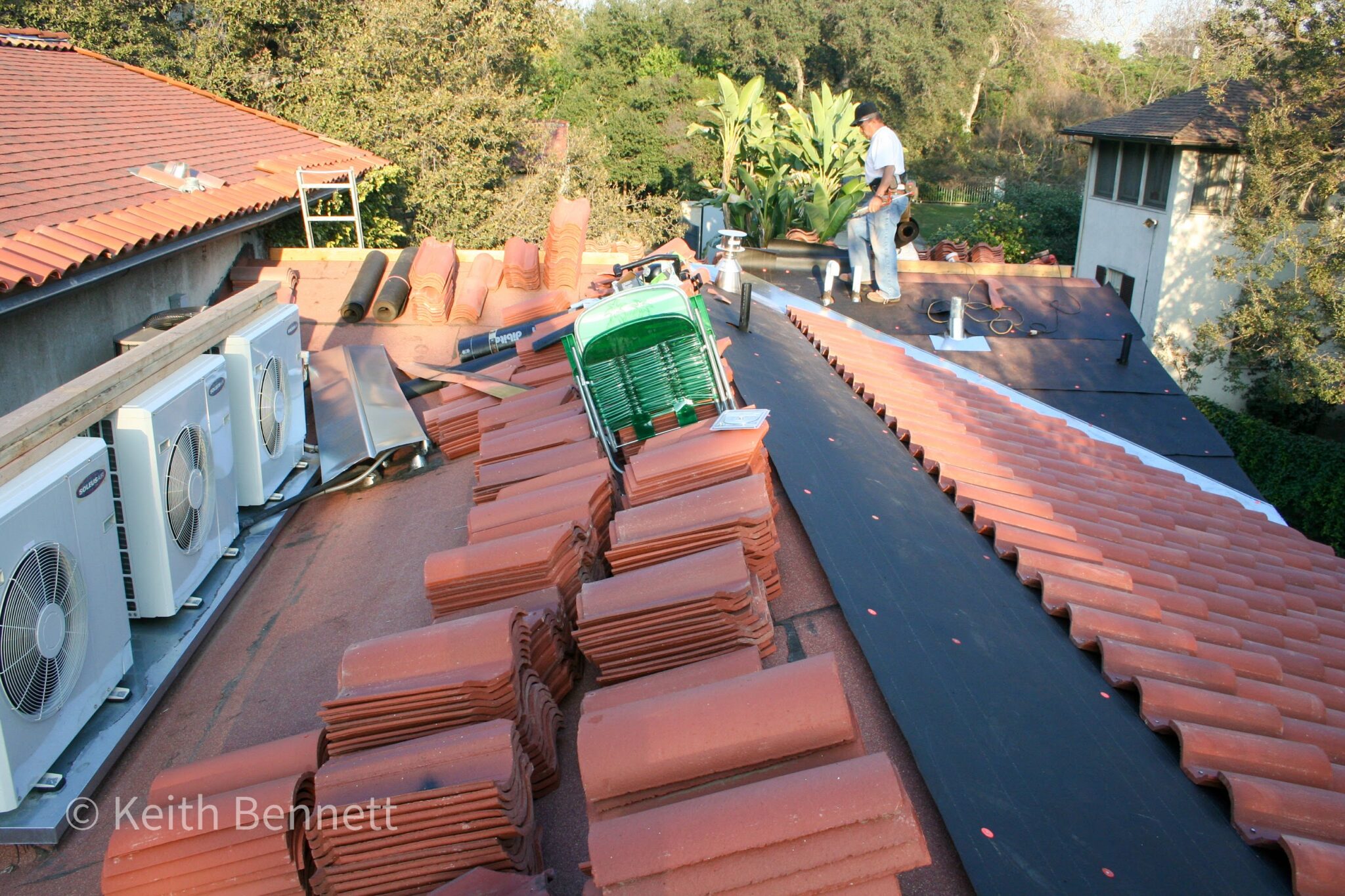 Four Mitsubishi mini split inverter units installed on rooftop of La Habra Heights hillside estate during tile roof replacement, showing multiple zone setup