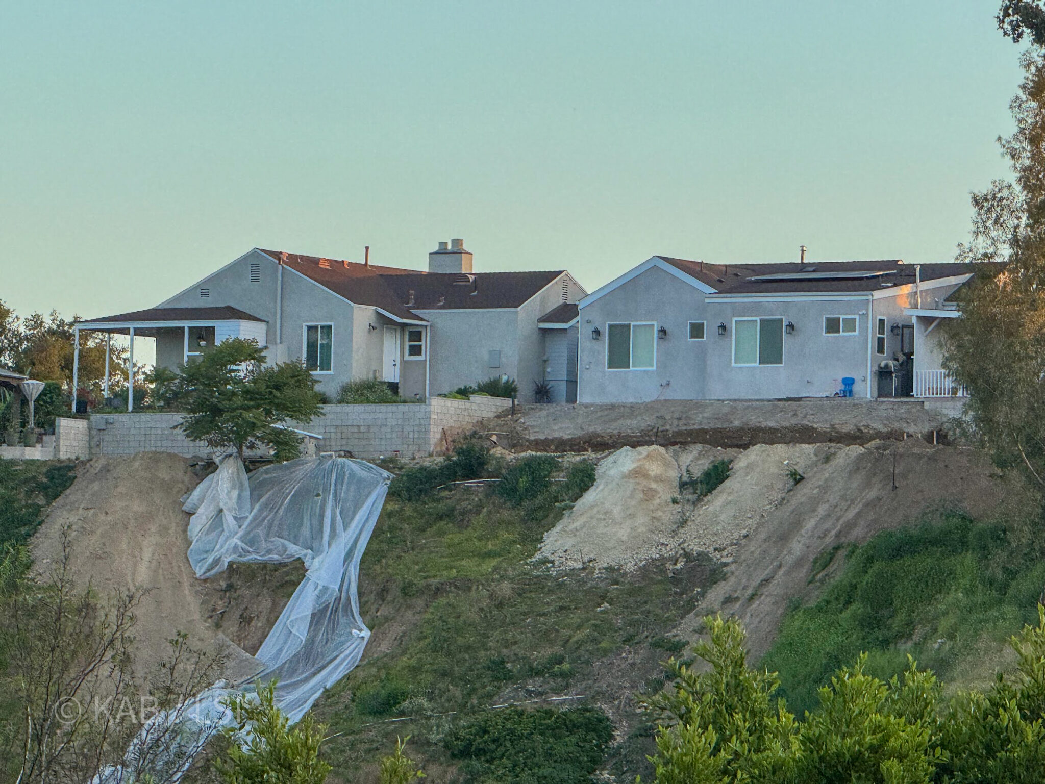 Hillside slope failure — Laurel Canyon area, Los Angeles. A house in serious distress from unstable terrain, photographed from the concrete hillside project across the canyon.